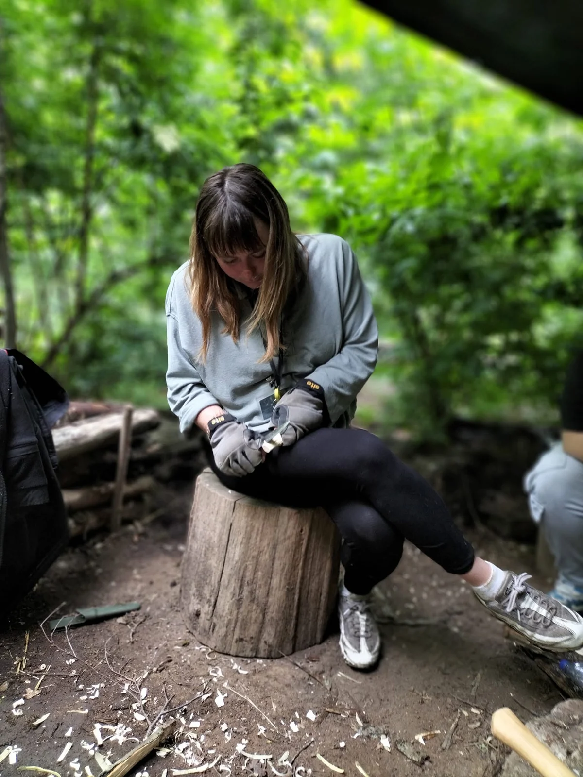 A learner concentrating on a practical woodcraft activity