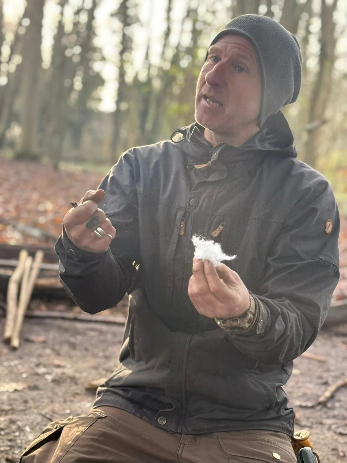 A participant examining materials during a woodland session